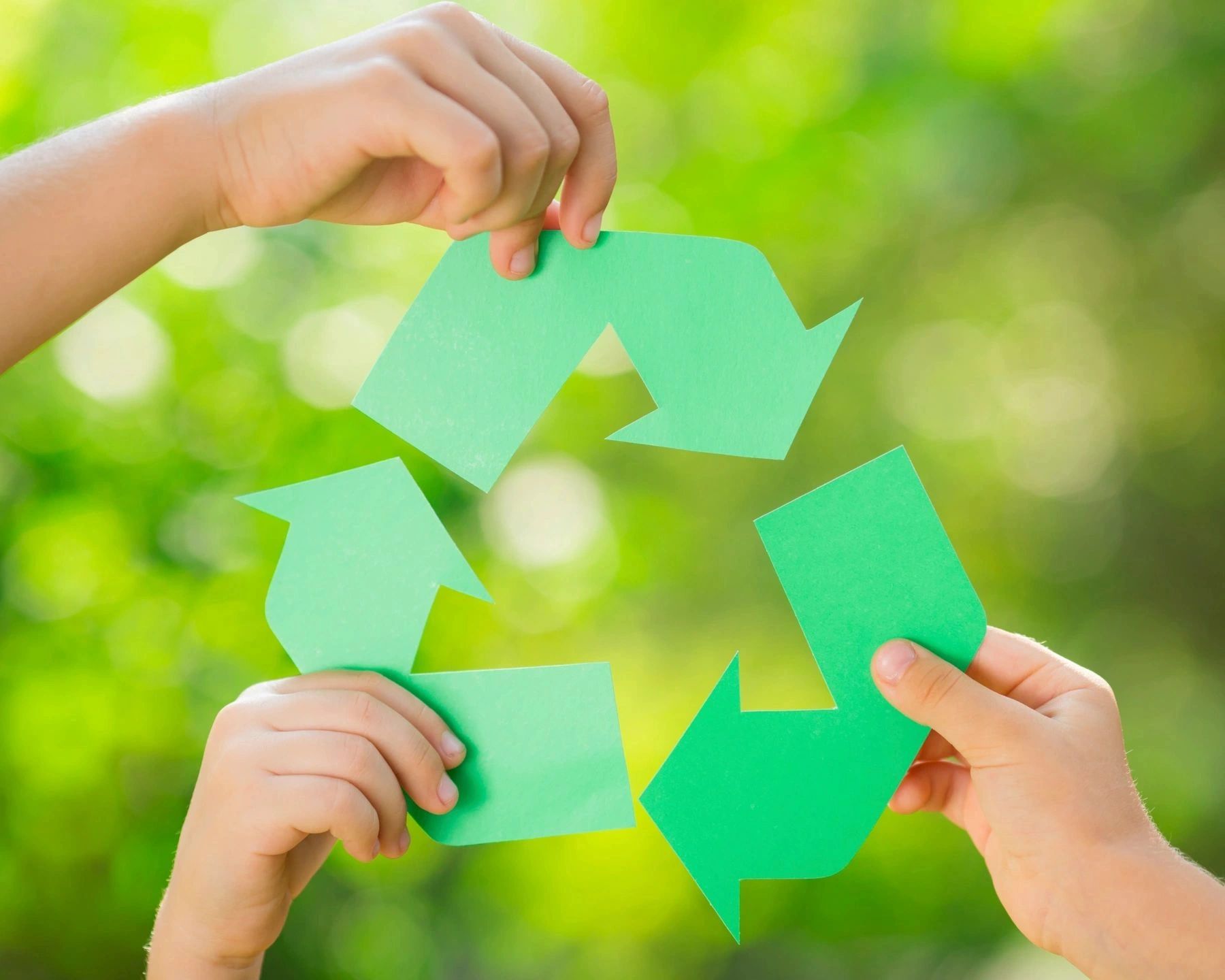 Recycled paper and green recycling arrows